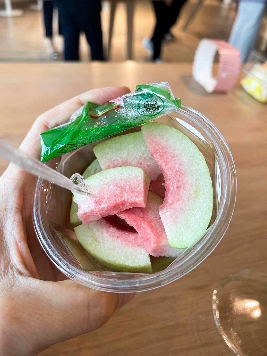 Fresh-cut fruit cup held in a hand